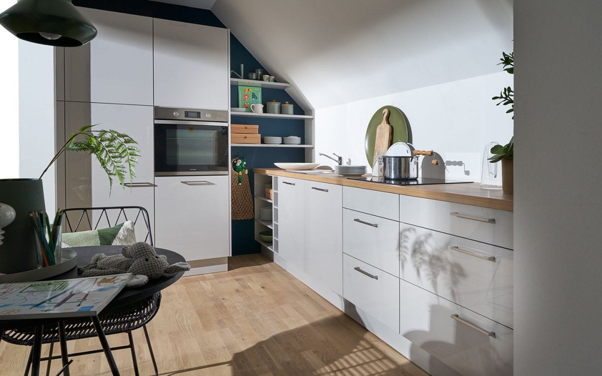 Kitchen under a sloping ceiling: functional and stylish