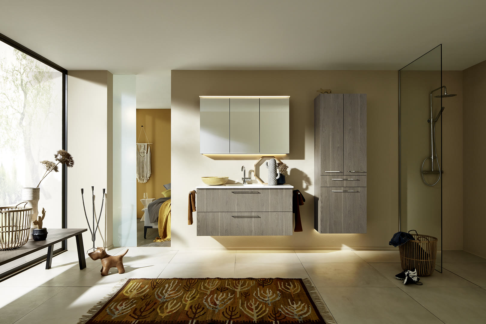 Gray wood-grain floating vanity with a freestanding soaking tub and glass walk-in shower in a warm neutral bathroom