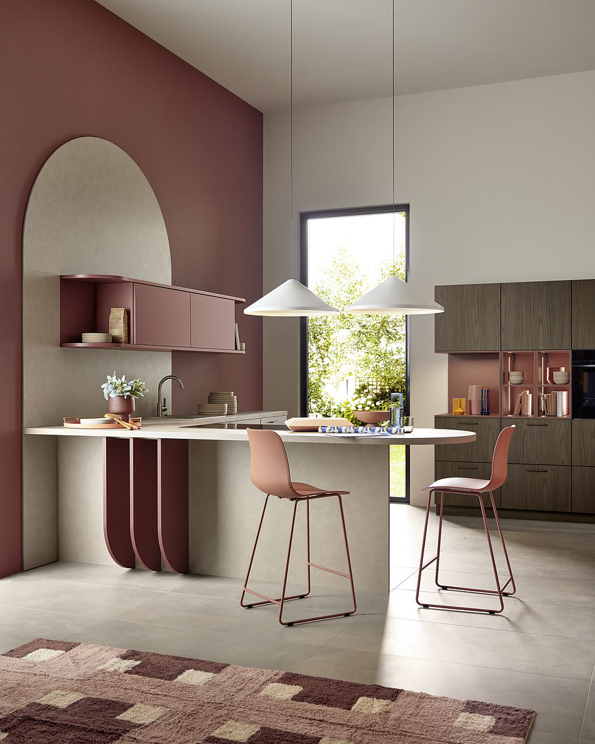 Kitchen with Soft Lack fronts in henna red soft-matt and Leaf and Noce Marone walnut.