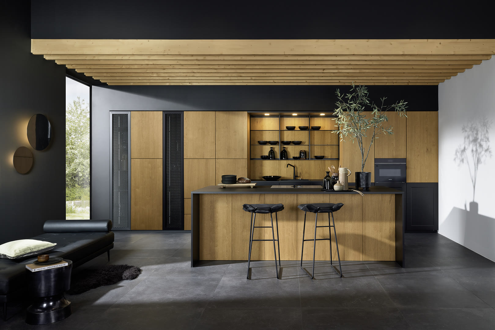 Living space with neoNATURE fronts in Cottage oak and Frame Lack in black soft-matt.