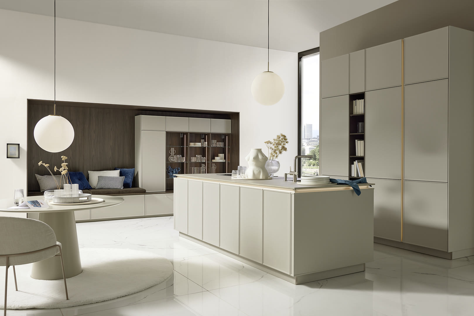 Modern kitchen with cream handleless cabinetry, a wood-topped island, and tall storage units.