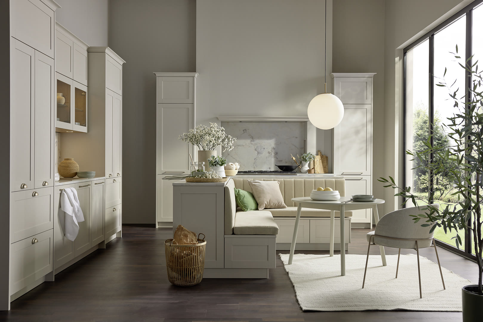 Kitchen with white shaker cabinets, a central island, marble backsplash, and pendant lighting.